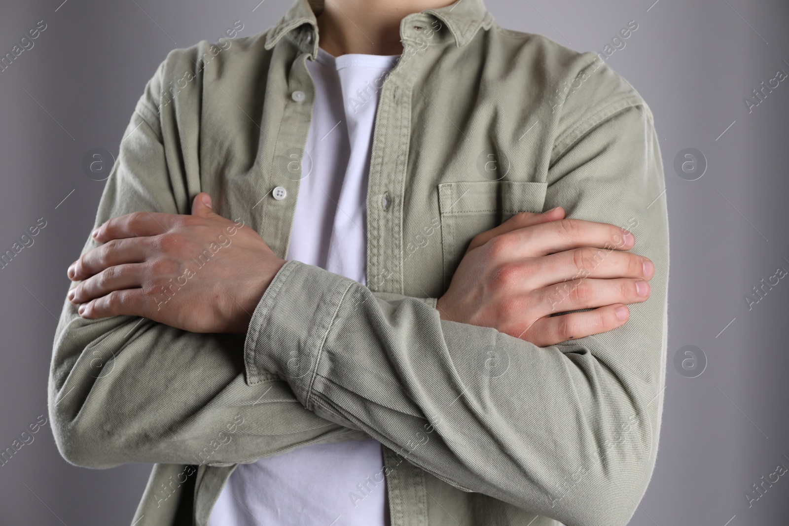 Photo of Man with space for tattoo on his hands against grey background, closeup