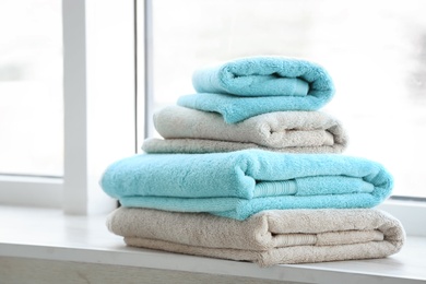 Photo of Stack of clean towels on window sill