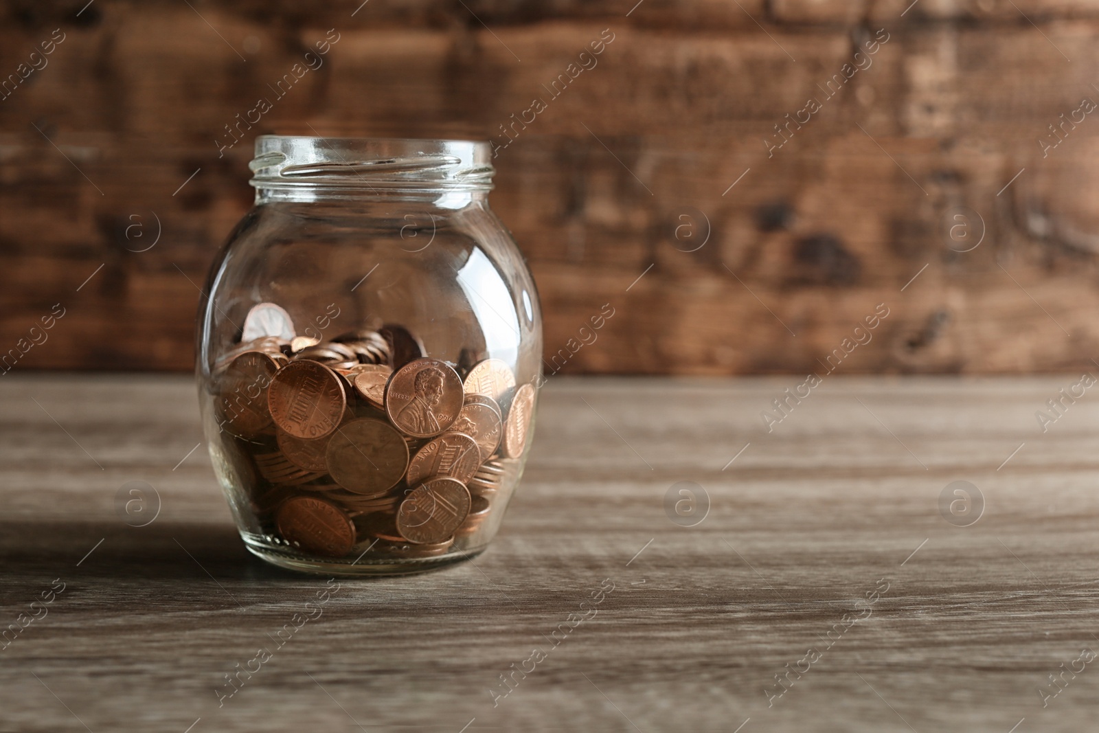 Photo of Donation jar with coins on table. Space for text