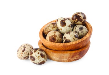 Wooden bowls and quail eggs on white background