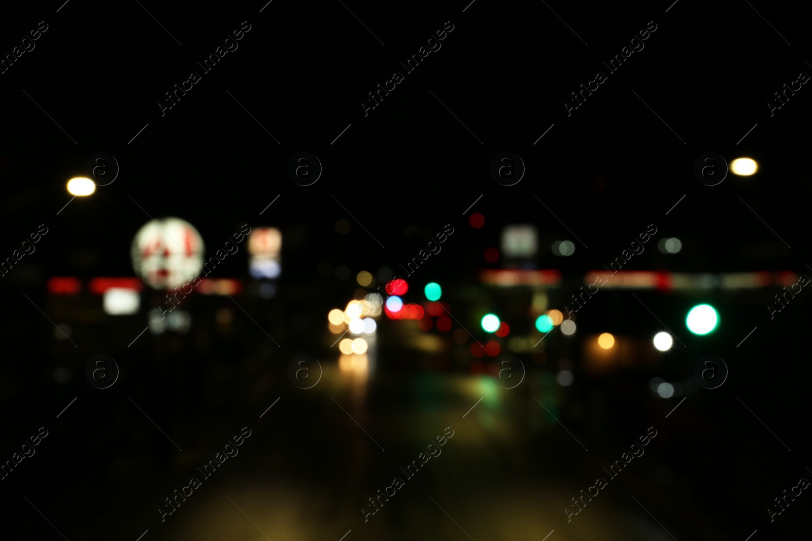 Photo of Blurred view of road with cars at night. Bokeh effect