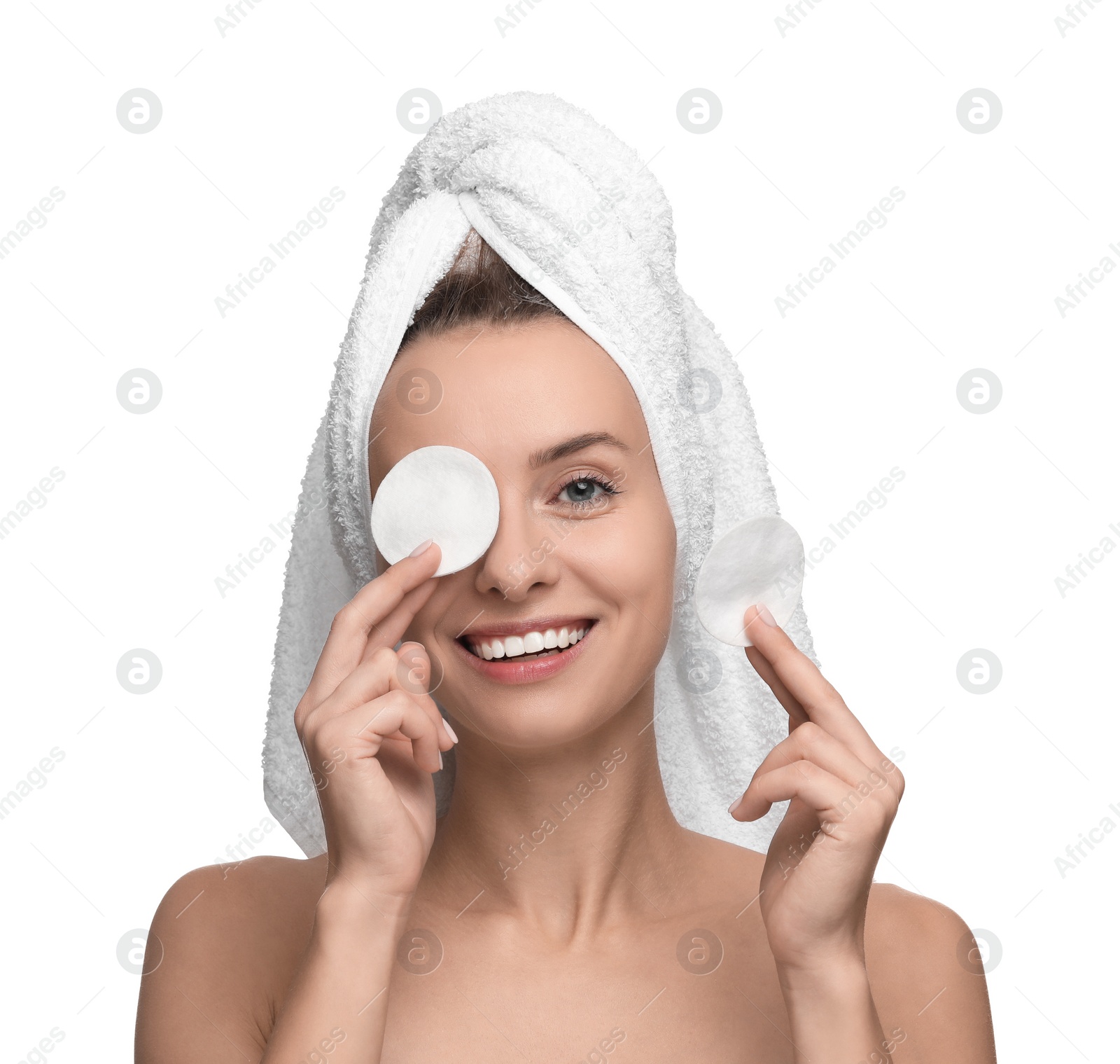 Photo of Smiling woman removing makeup with cotton pads on white background