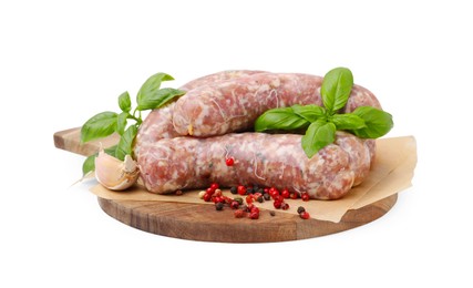 Photo of Wooden board with raw homemade sausages and different spices isolated on white