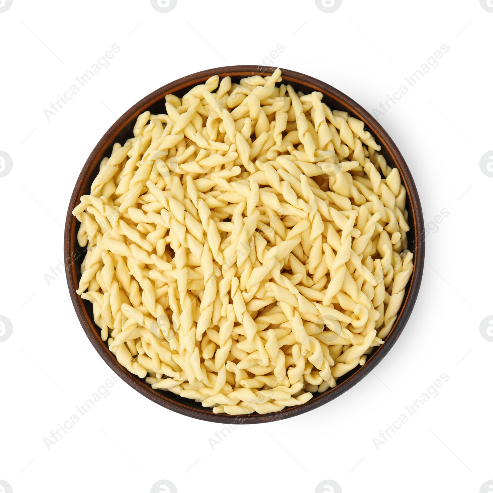 Photo of Uncooked trofie pasta in bowl isolated on white, top view