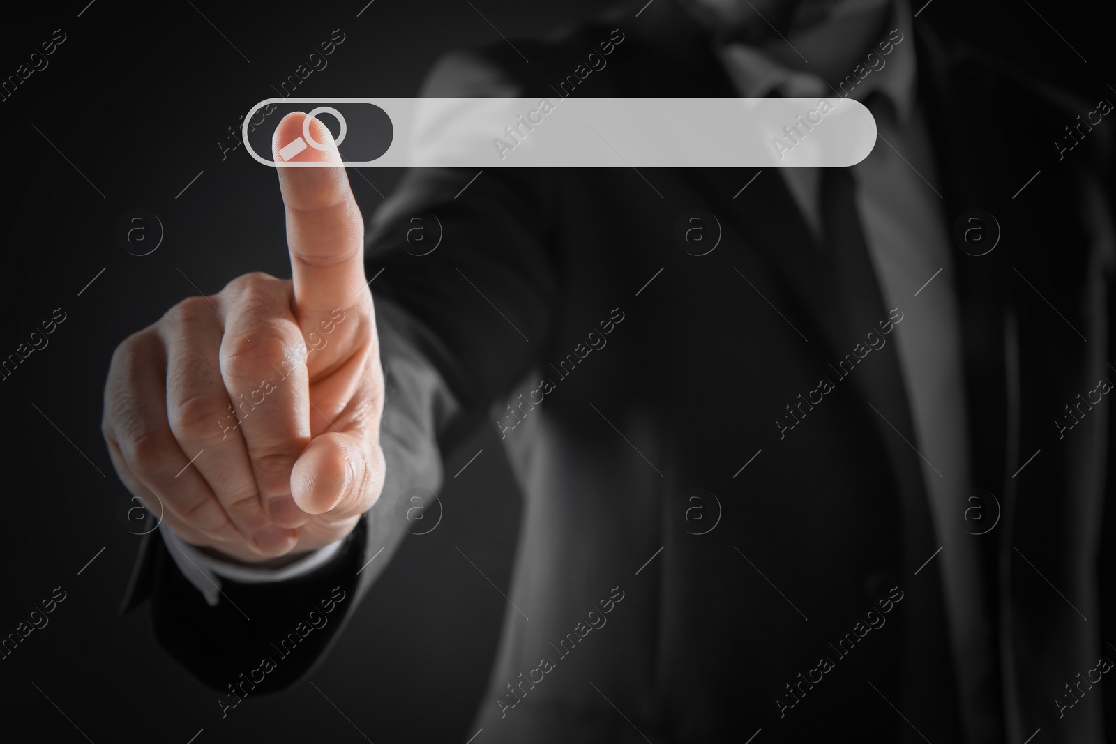 Image of Man pointing at search bar on virtual screen against dark background, closeup