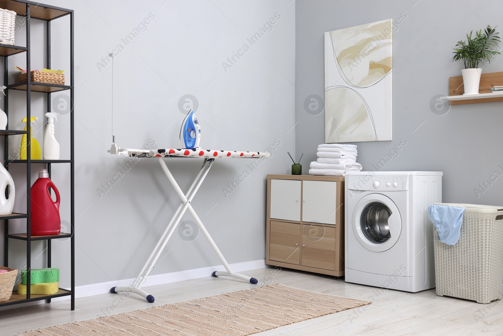 Photo of Laundry room interior with washing machine and furniture