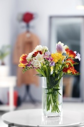 Photo of Beautiful bouquet of freesia flowers indoors