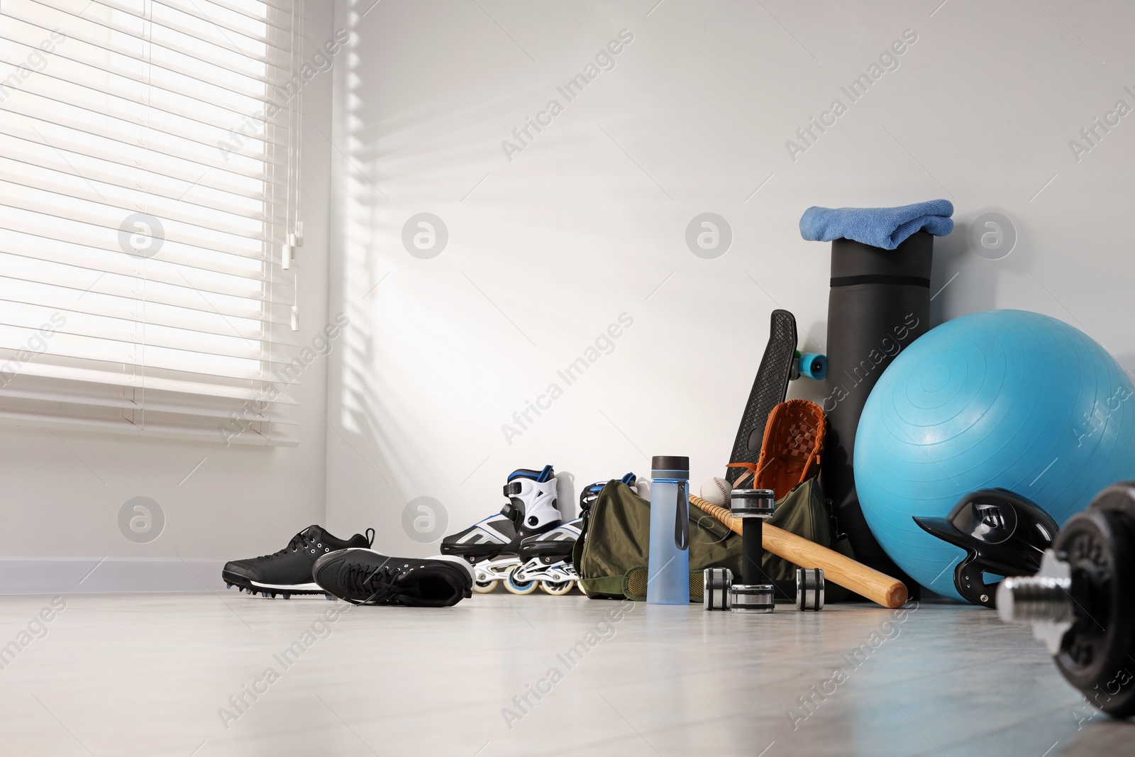 Photo of Many different sports equipment near wall indoors, space for text