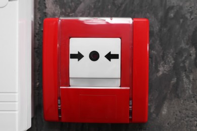 Photo of Fire alarm push button on grey wall