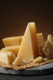 Photo of Marble board with delicious cheese on table