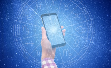 Image of Woman with smartphone reading daily horoscope, closeup