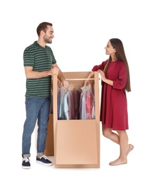 Young couple near wardrobe box on white background