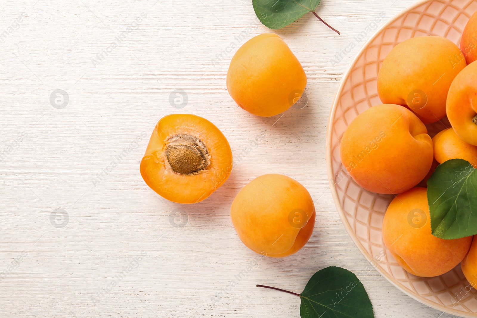 Photo of Composition with delicious ripe apricots on white wooden background, top view. Space for text