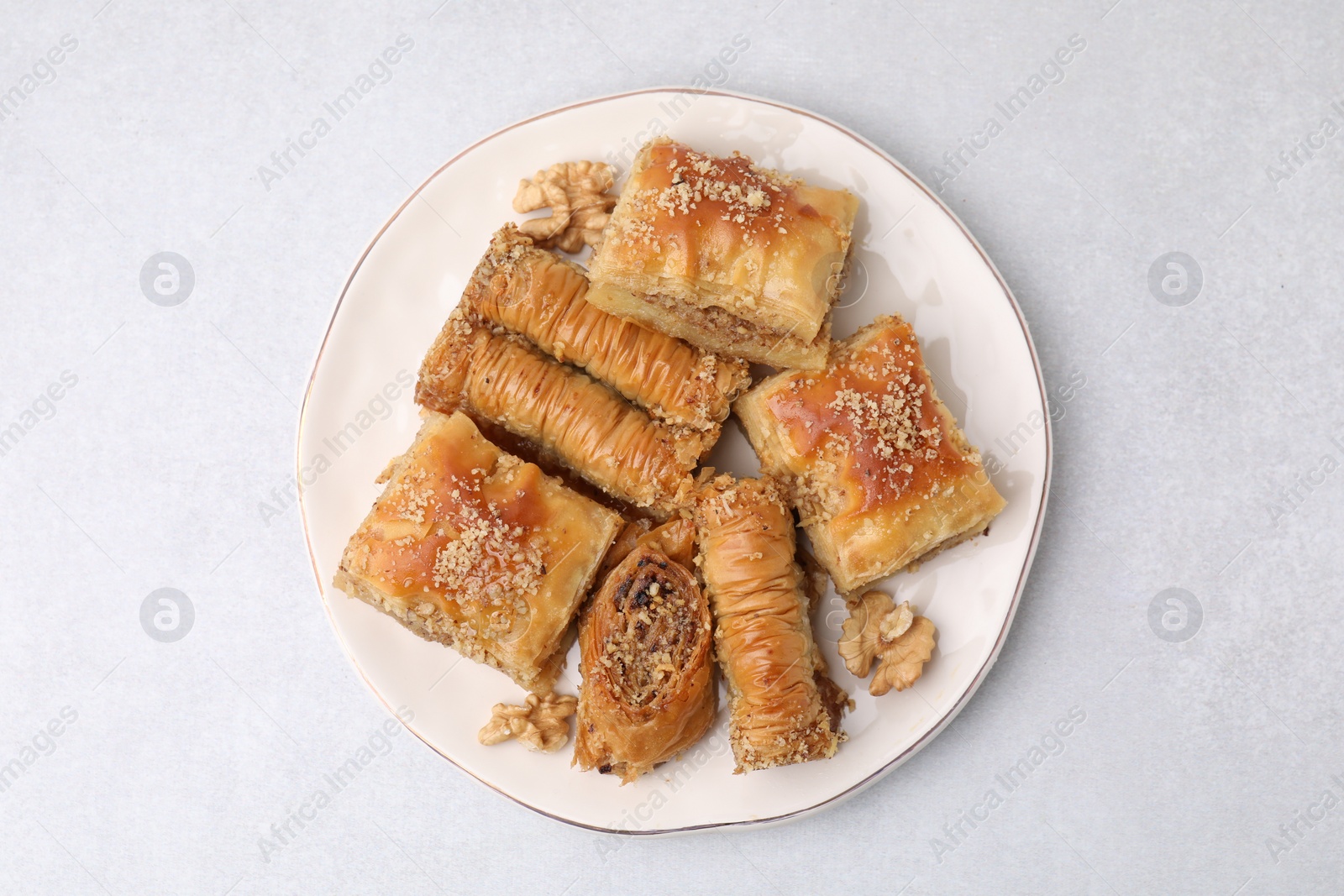 Photo of Eastern sweets. Pieces of tasty baklava on white table, top view