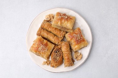 Photo of Eastern sweets. Pieces of tasty baklava on white table, top view