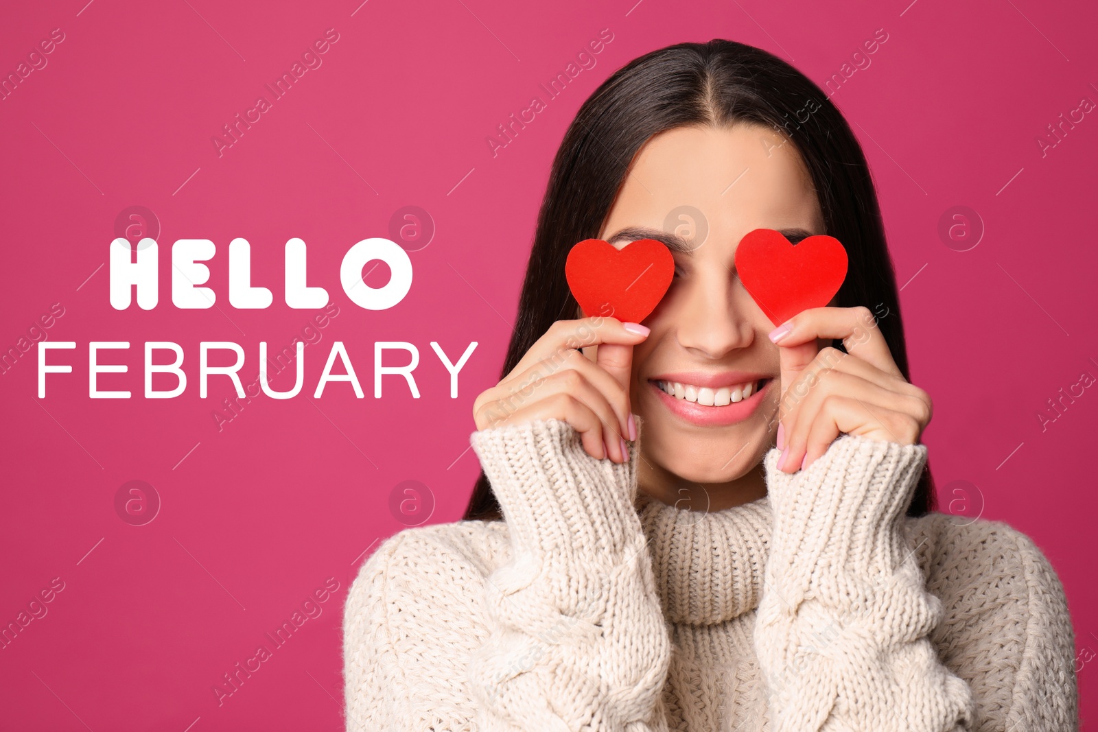 Image of Greeting card with text Hello February. Young woman holding paper hearts near eyes on pink background