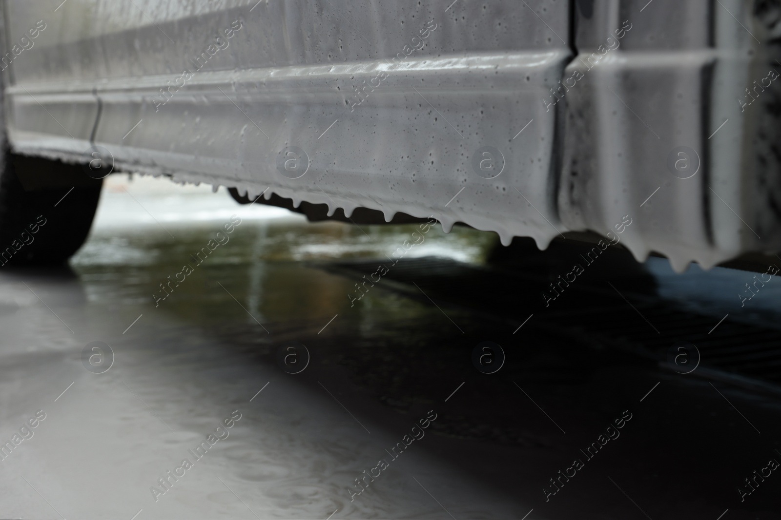 Photo of Auto with cleaning foam at car wash, closeup