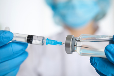 Doctor filling syringe with medication, closeup. Vaccination and immunization