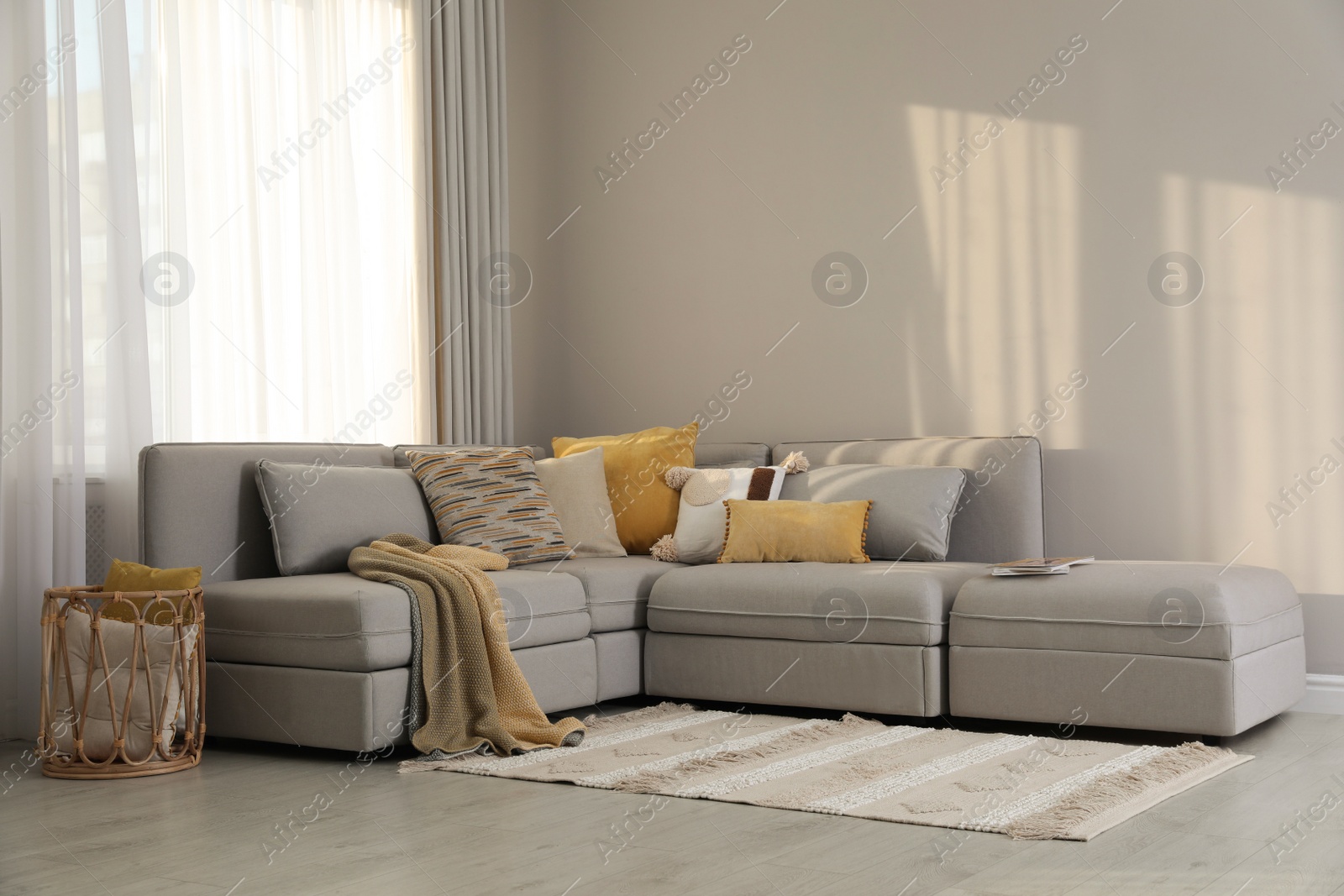 Photo of Living room interior with large grey sofa