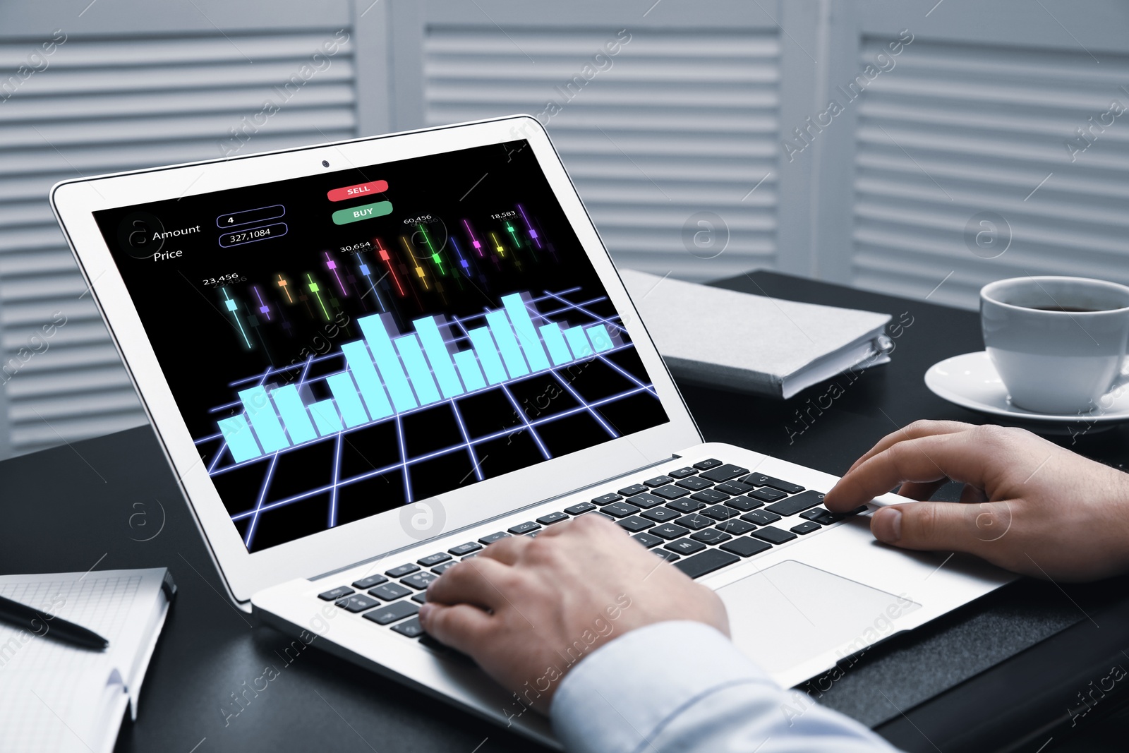 Image of  Broker working with laptop at table, closeup. Forex trading