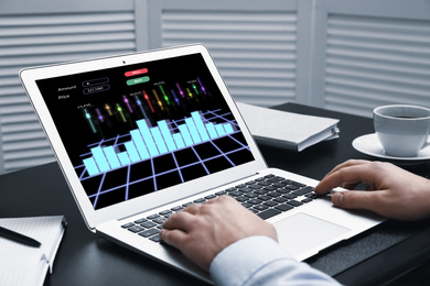  Broker working with laptop at table, closeup. Forex trading