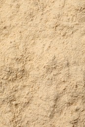 Heap of buckwheat flour as background, top view