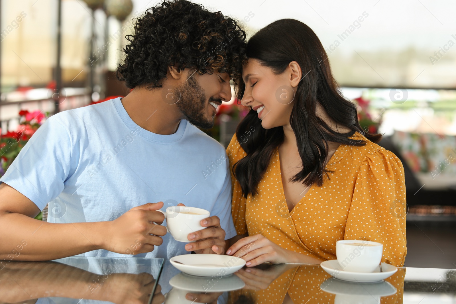 Photo of International dating. Happy couple spending time together in restaurant