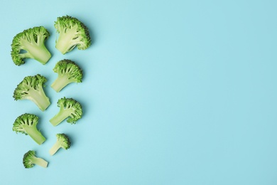 Photo of Flat lay composition with fresh green broccoli on color background. Space for text