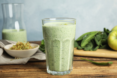 Tasty green buckwheat smoothie on wooden table