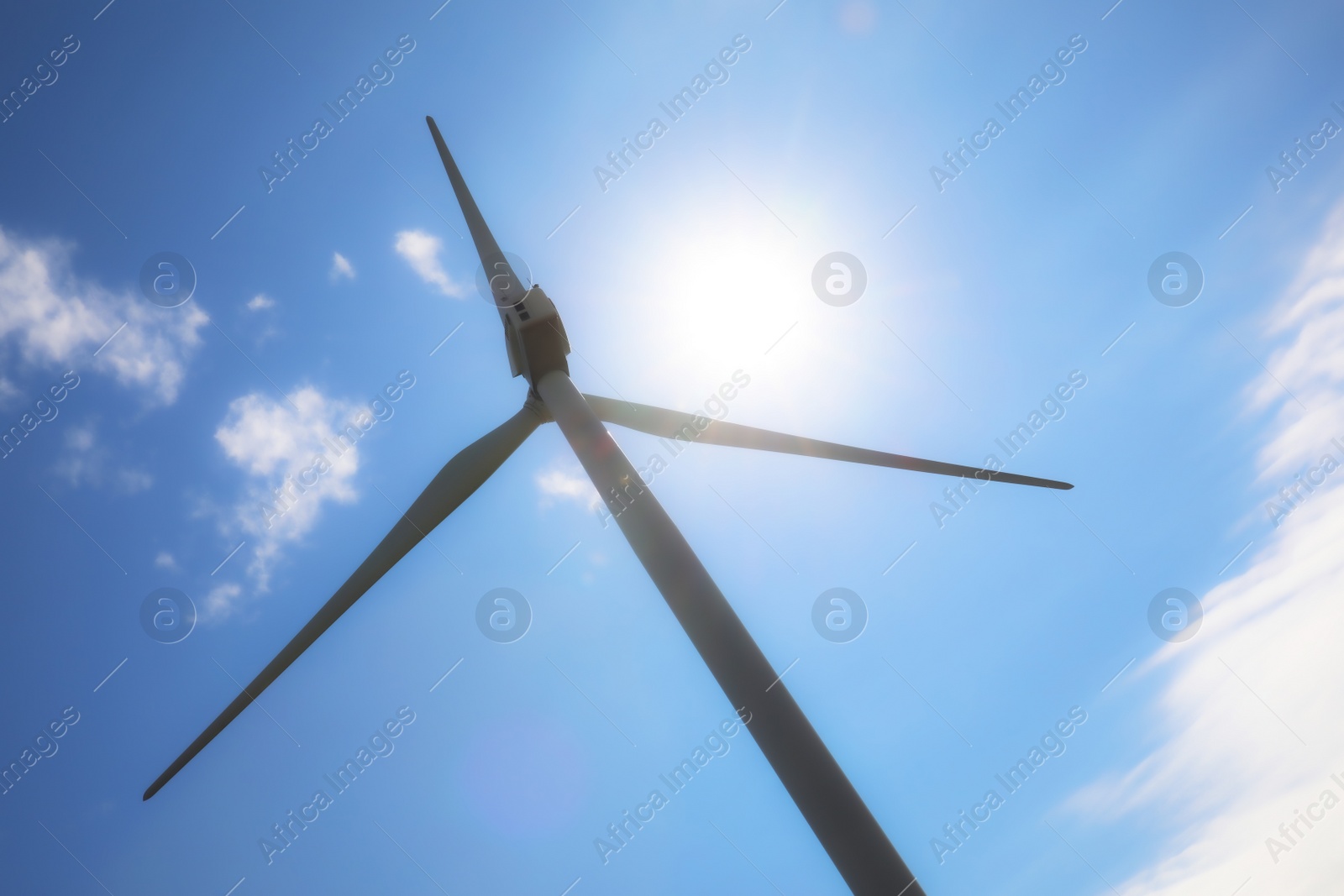 Photo of Wind turbine against beautiful blue sky, low angle view. Alternative energy source