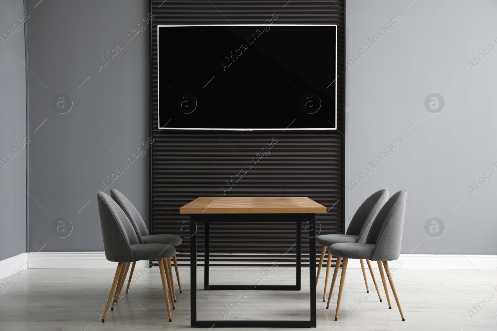 Image of Modern wide screen TV on wall in room with stylish furniture 