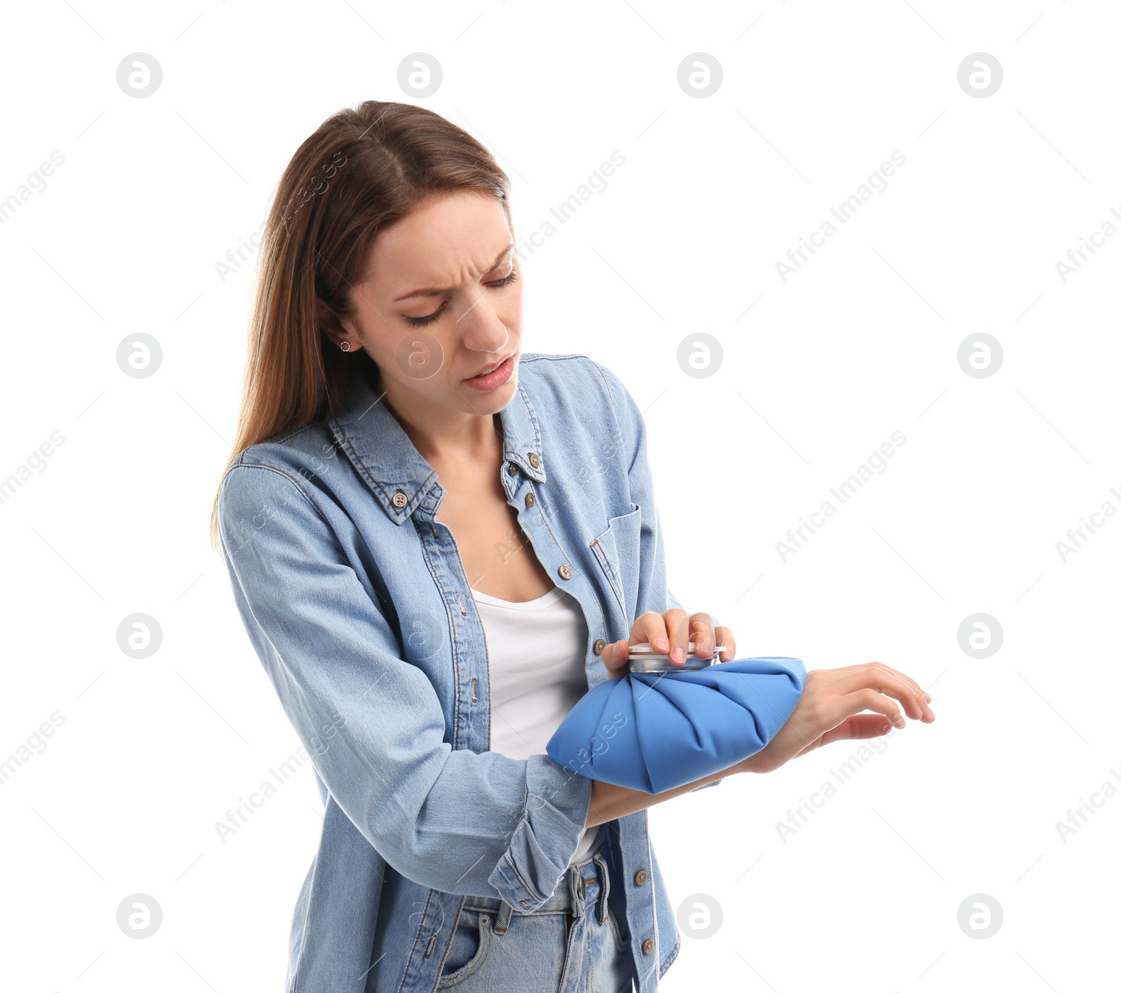 Photo of Woman applying cold compress to relieve wrist pain on white background