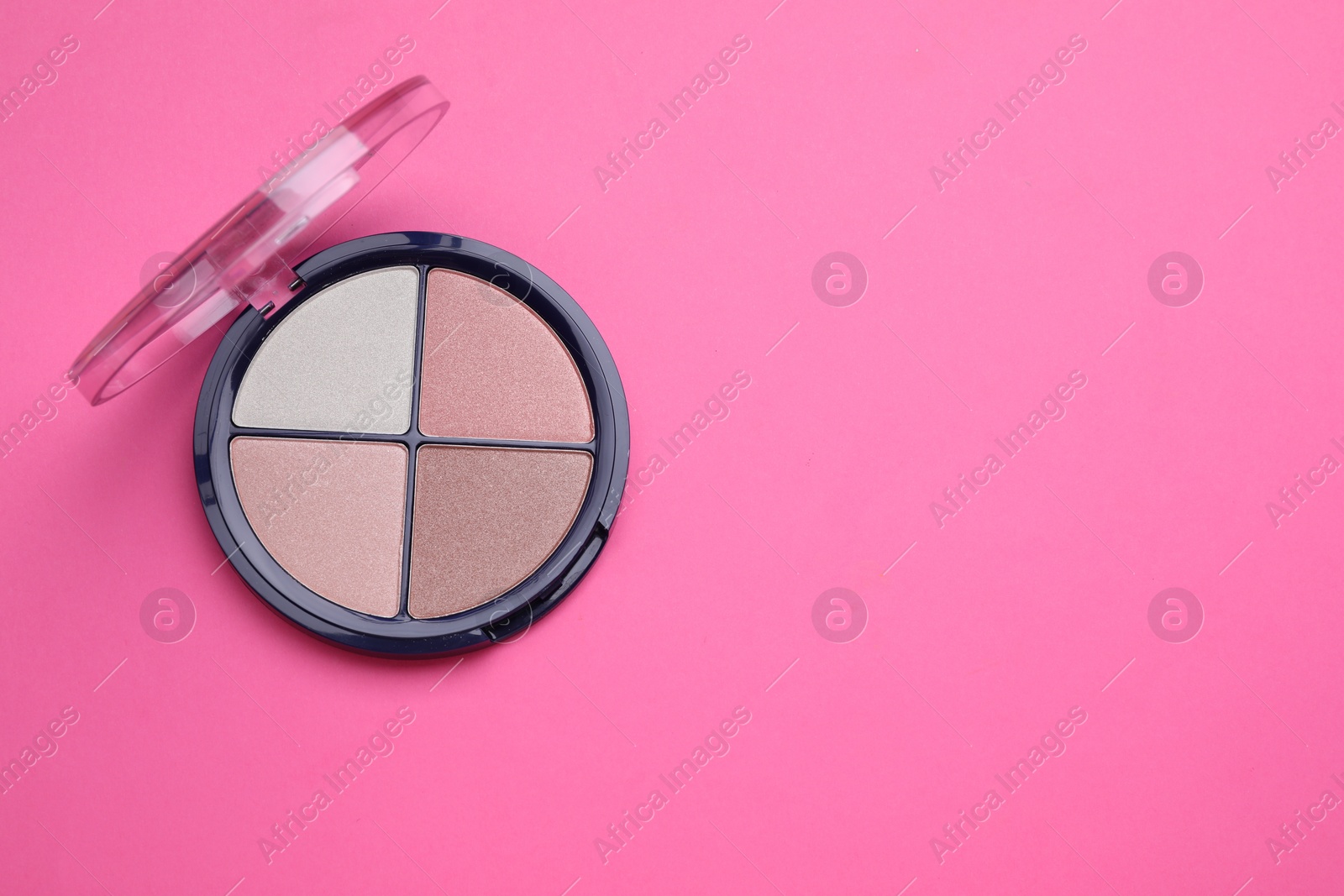 Photo of Colorful contouring palette on pink background, top view with space for text. Professional cosmetic product