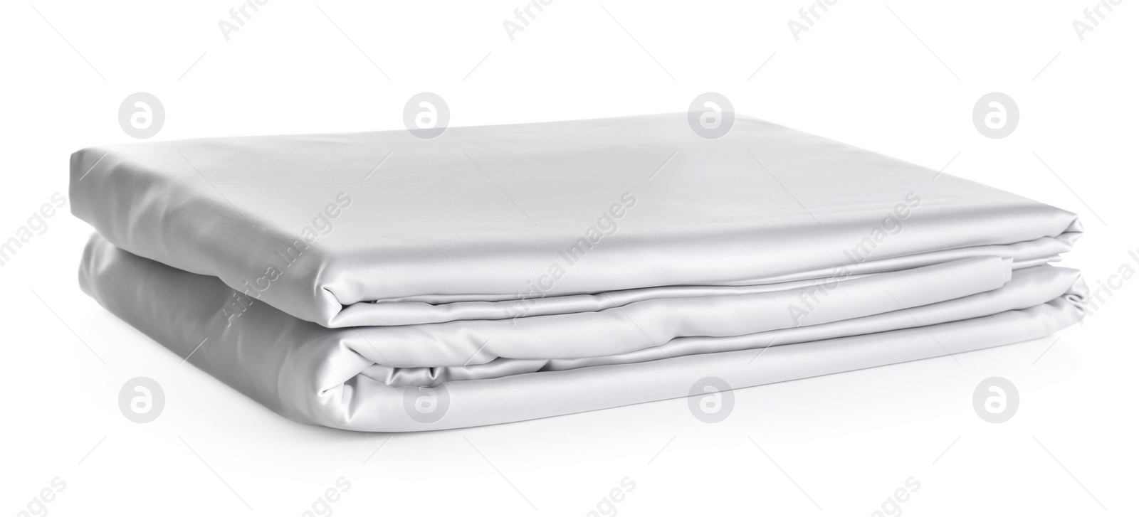 Photo of Stack of clean silky bed linen isolated on white