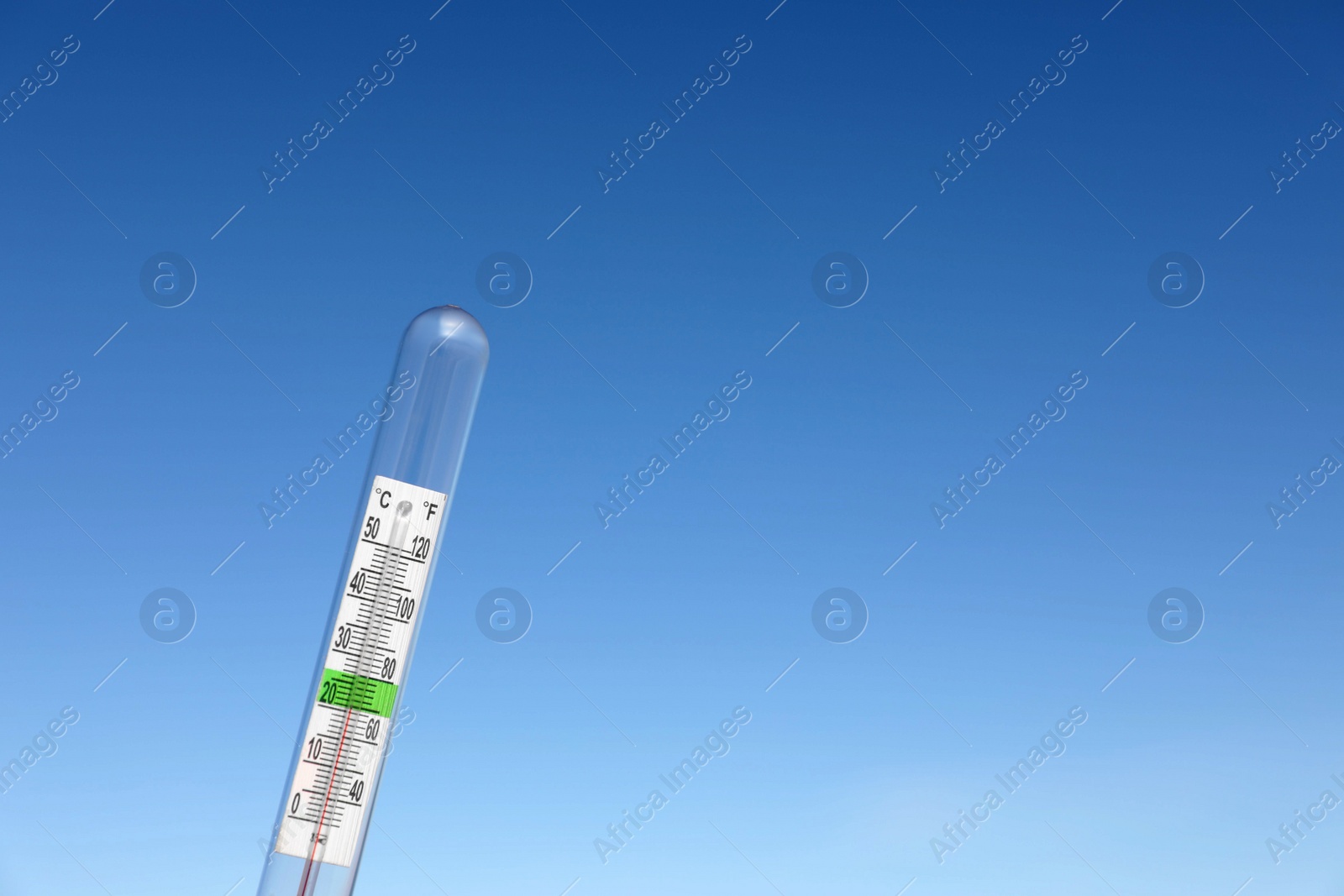 Photo of Weather thermometer against blue sky, space for text