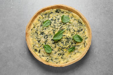 Delicious homemade spinach pie on light grey table, top view