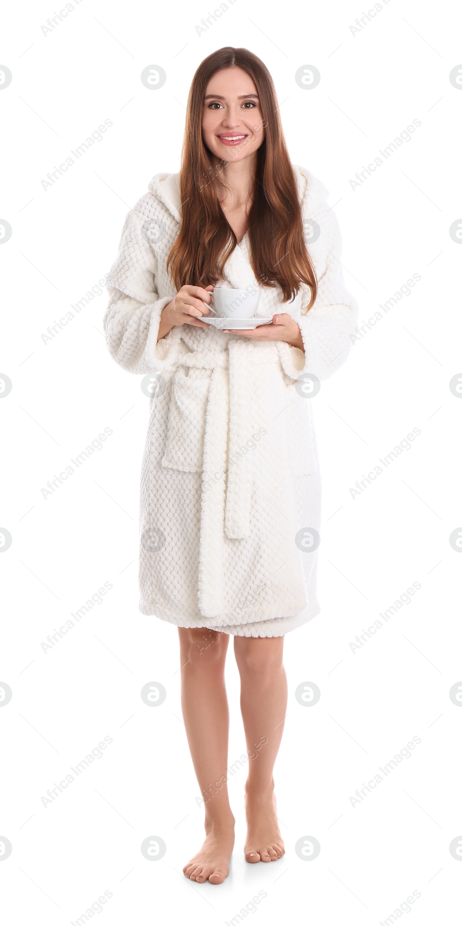 Photo of Young woman in bathrobe with cup of drink on white background