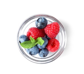 Photo of Bowl with raspberries and blueberries on white background