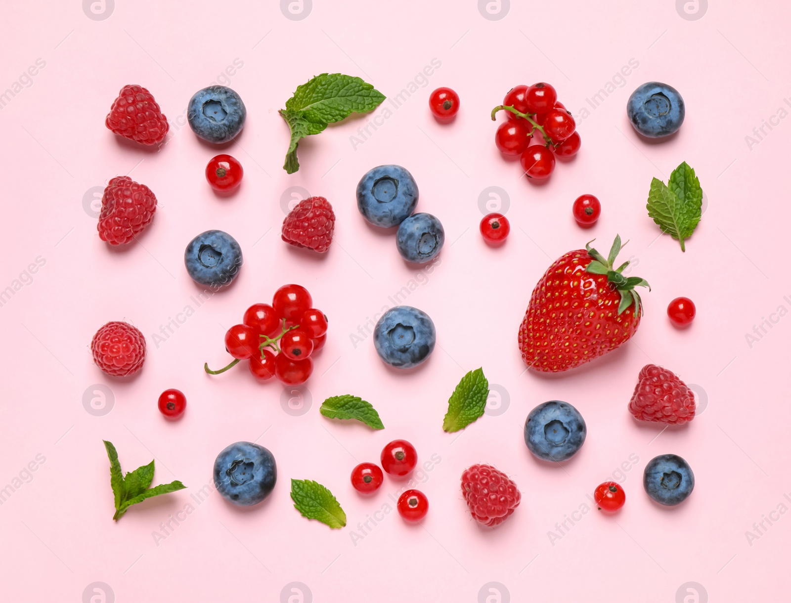 Photo of Different fresh berries on pink background, top view