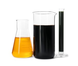 Beaker, test tube and flask with different types of oil isolated on white