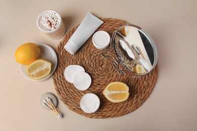 Lemon face wash. Fresh citrus fruits, personal care products and mirror on beige background, flat lay