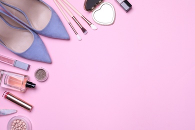 Photo of Flat lay composition with women's shoes and different makeup products on pink background. Space for text