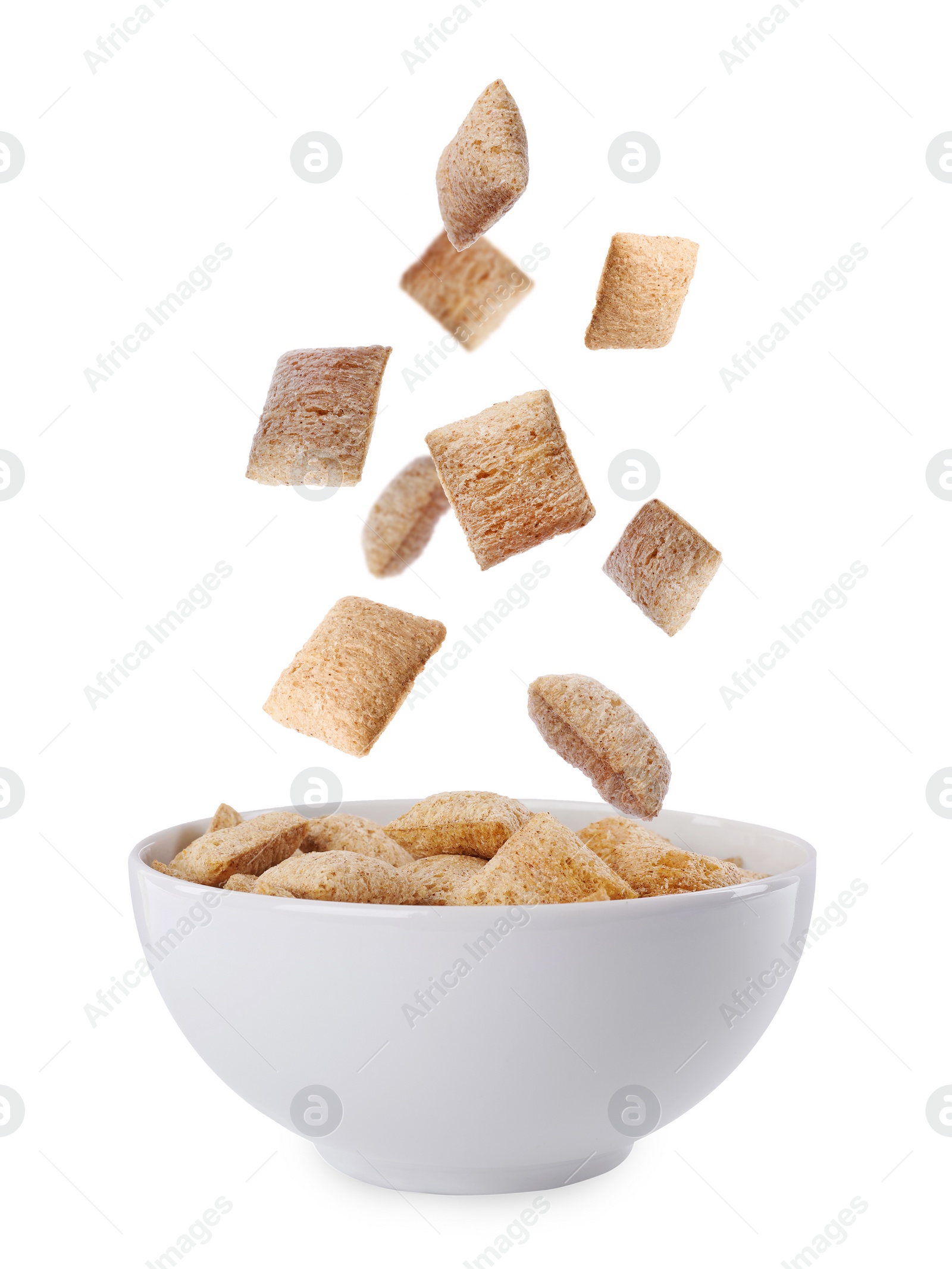 Image of Sweet crispy corn pads falling into bowl with milk on white background 