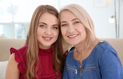 Photo of Young daughter and her mother at home