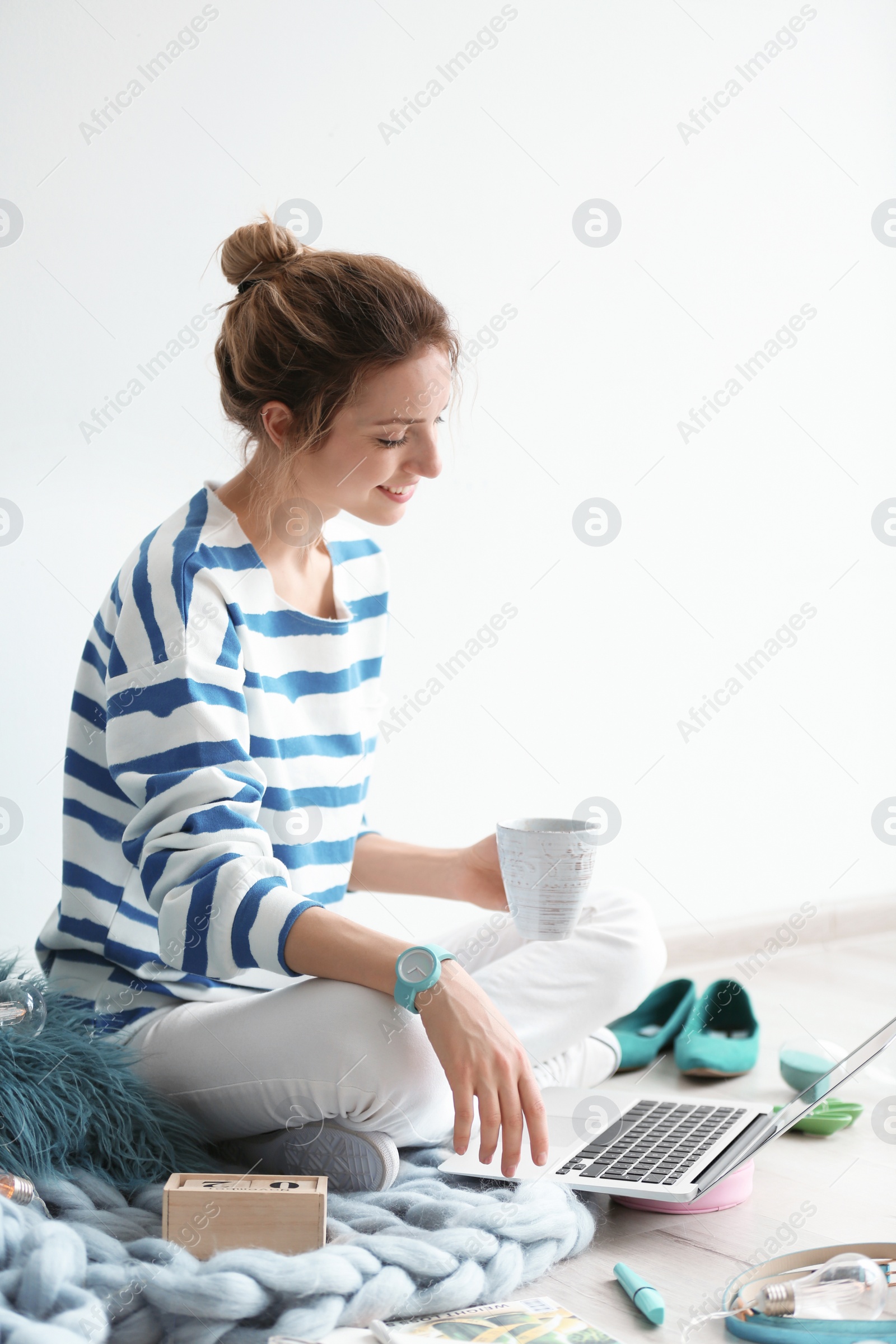 Photo of Female blogger with laptop and cup of coffee indoors