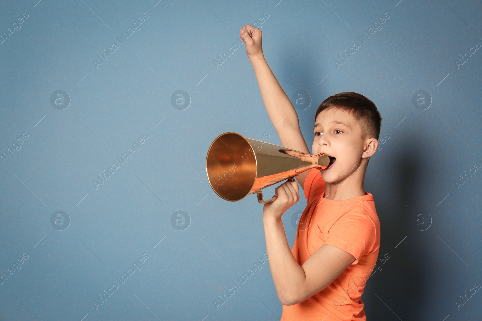 Photo of Cute little boy with megaphone on color background