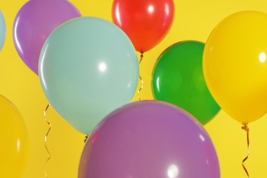 Photo of Bright balloons on color background. Celebration time