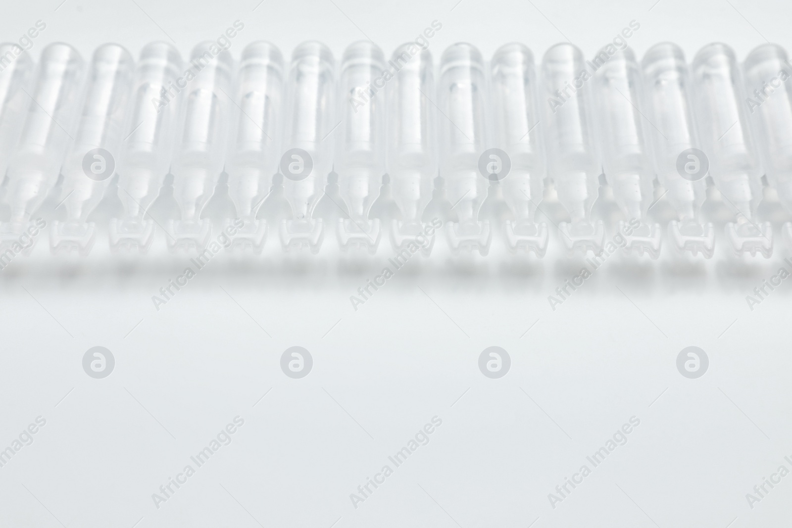 Photo of Single dose ampoules of sterile isotonic sea water solution on white background. Space for text