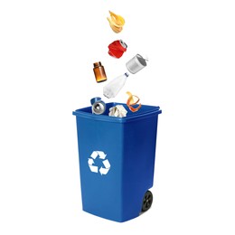 Image of Garbage falling into trash bin on white background