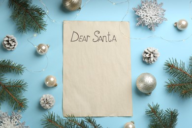 Photo of Flat lay composition with letter saying Dear Santa on light blue background. Space for text